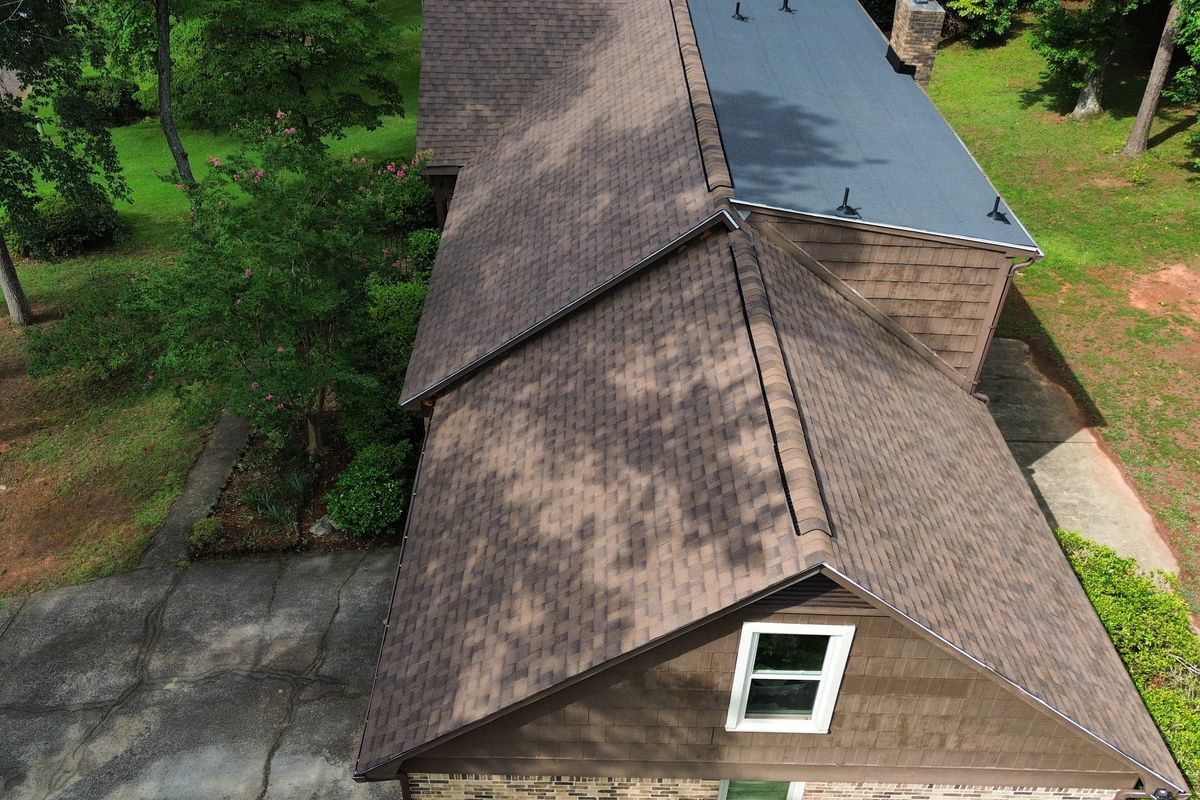 Drone view of a completed brown architectural shingle roof on a South Carolina home.