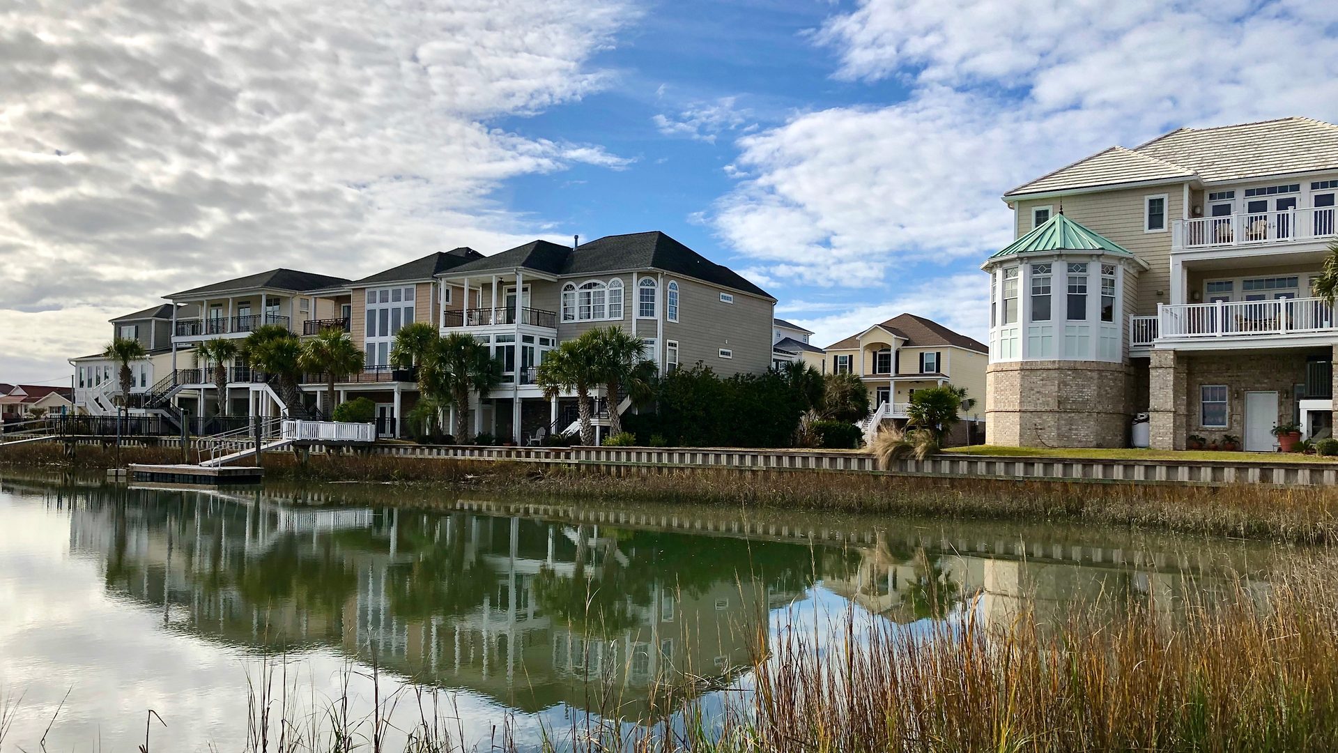 Waterfront South Carolina homes under a wide coastal sky.